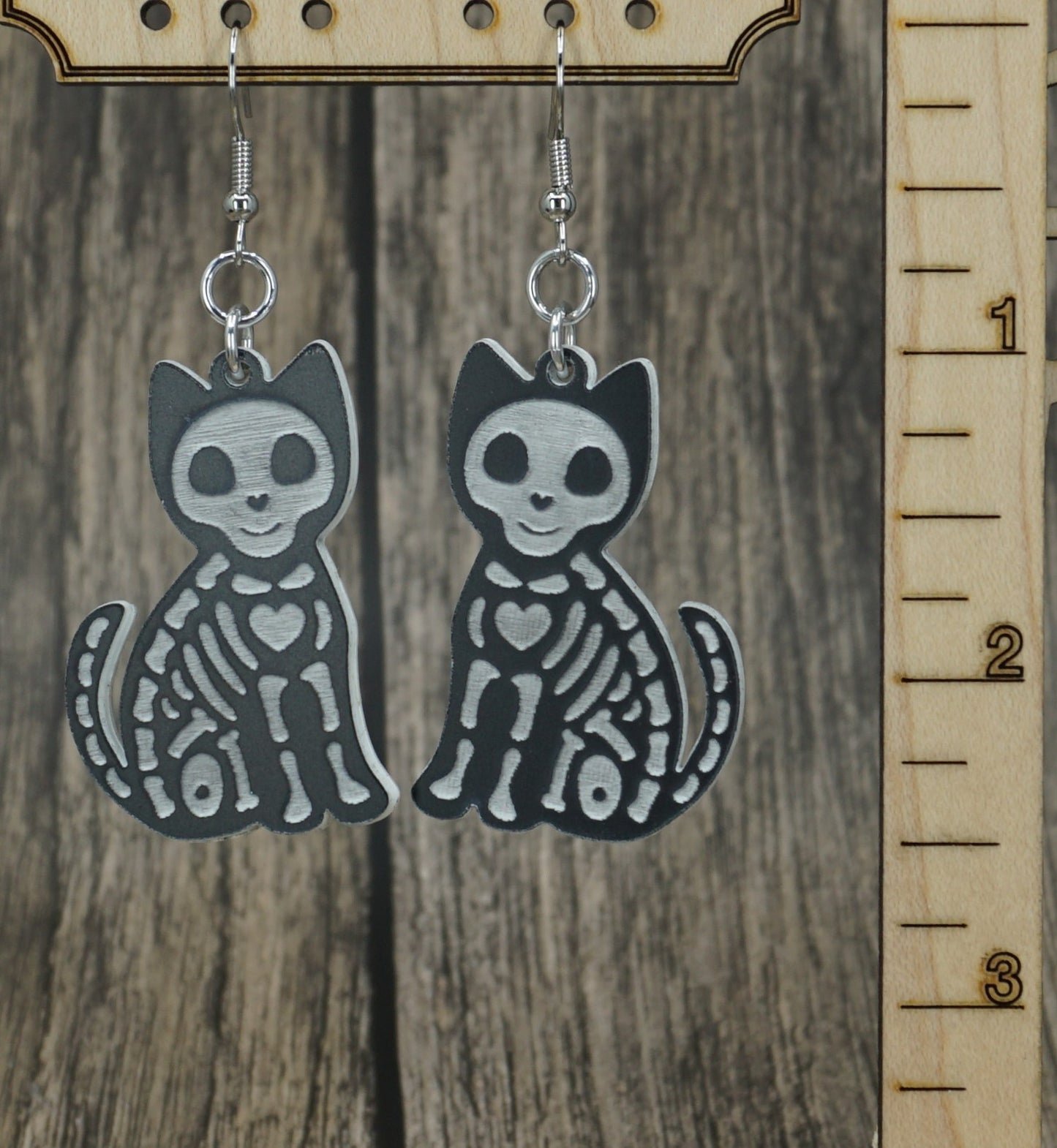 Black and white cat skeleton earrings