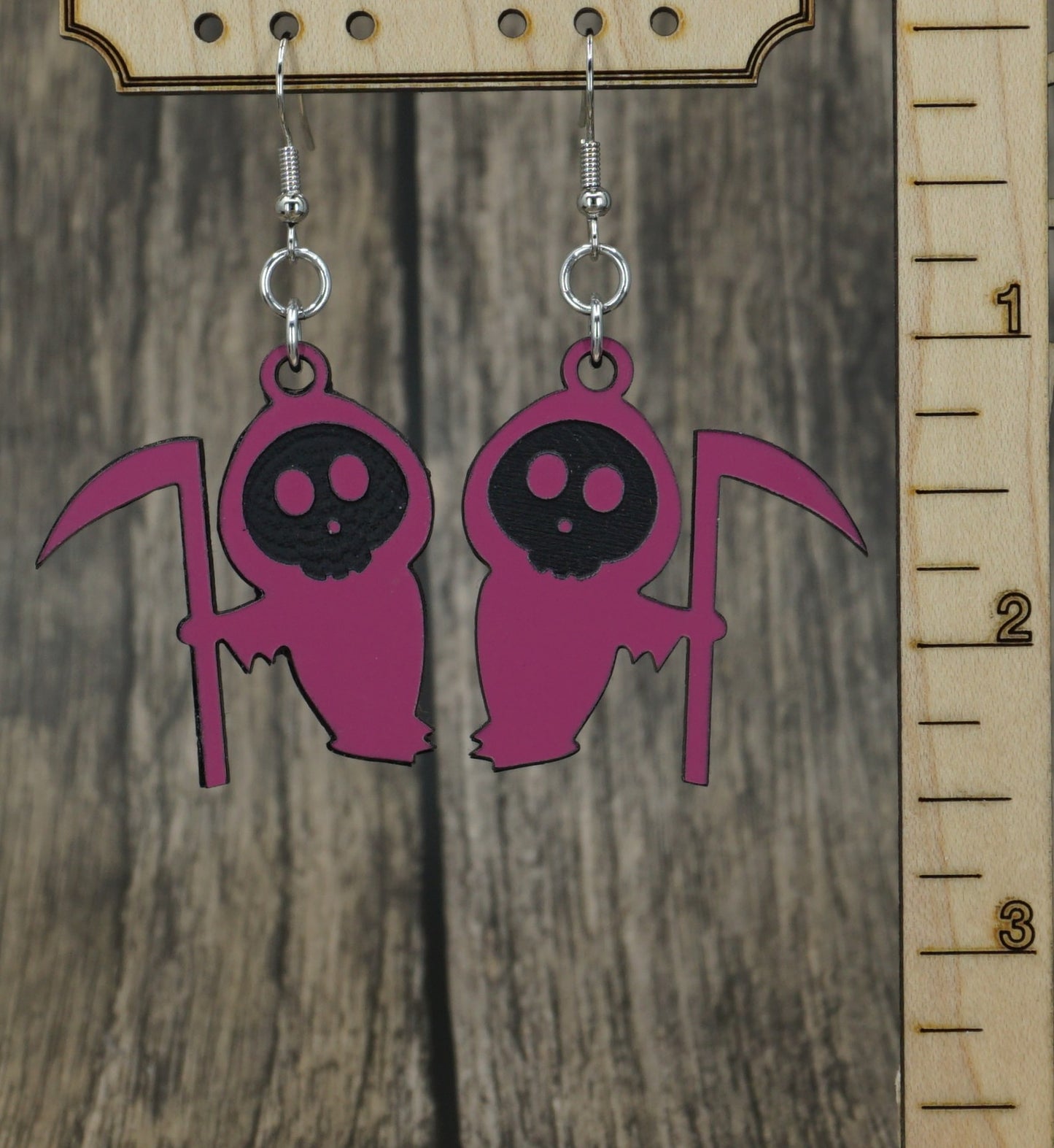 pink and black grim reaper earrings