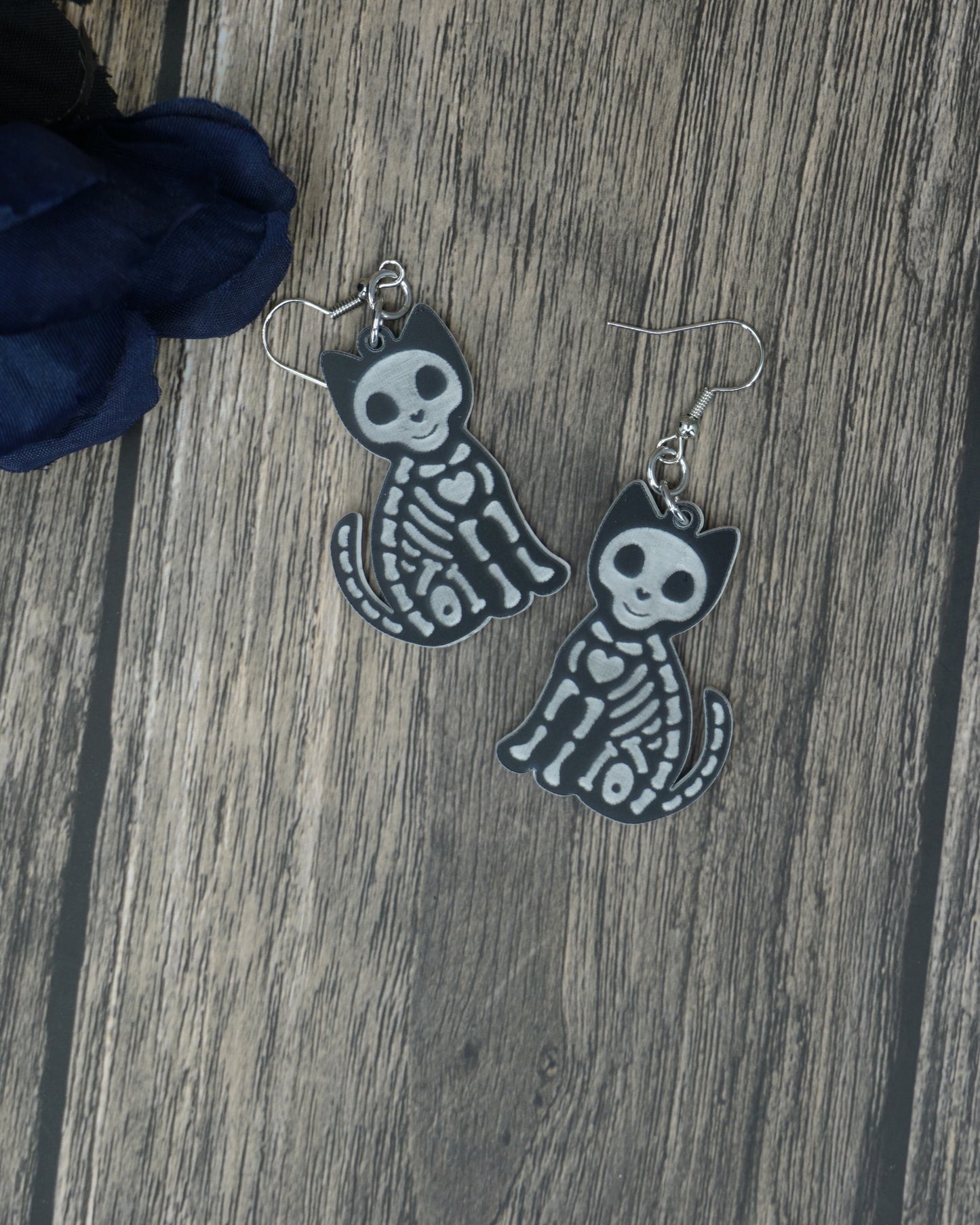 Black and white cat skeleton earrings