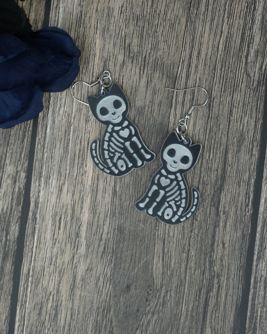 Black and white cat skeleton earrings