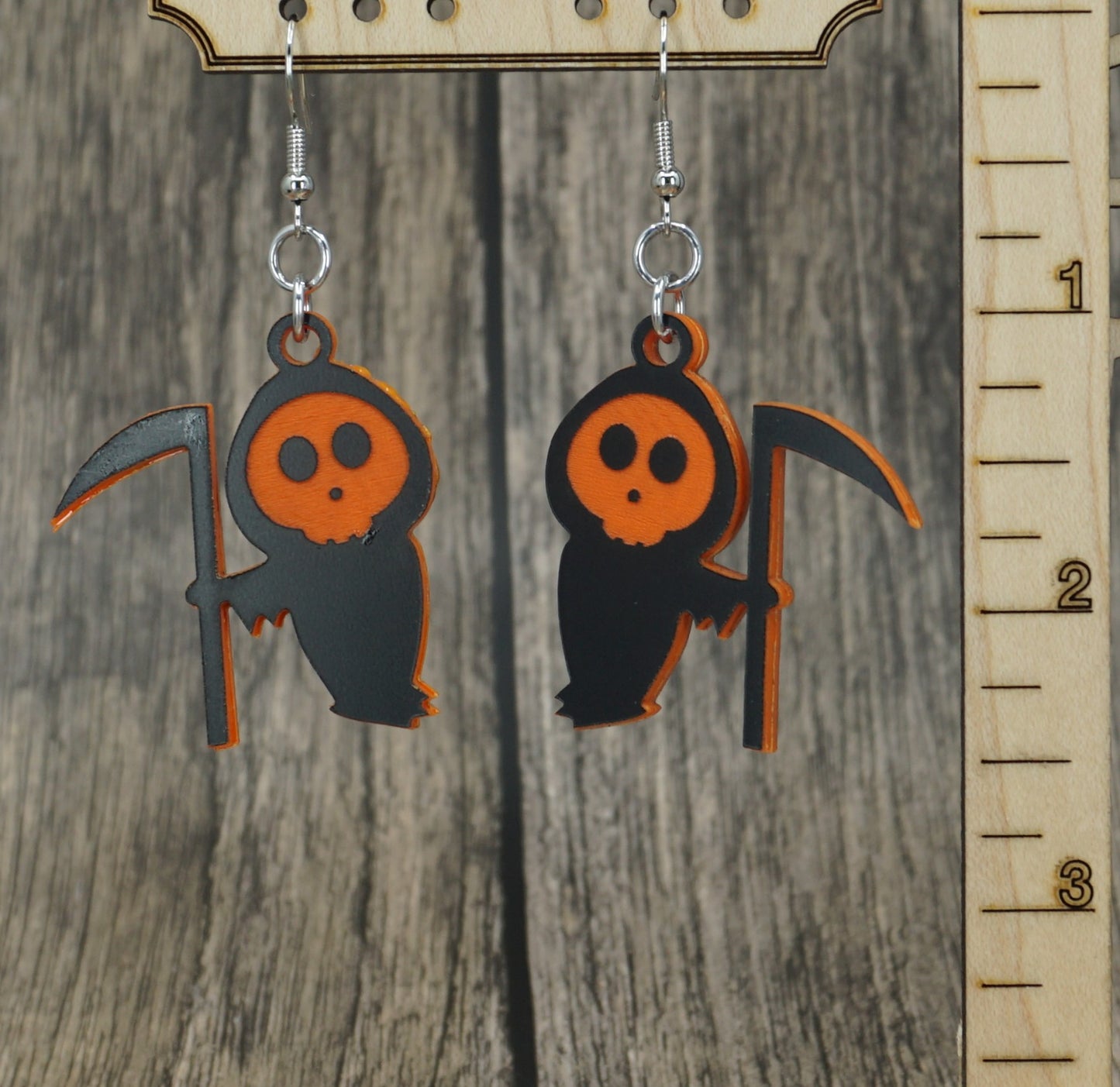 black and orange grim reaper earrings